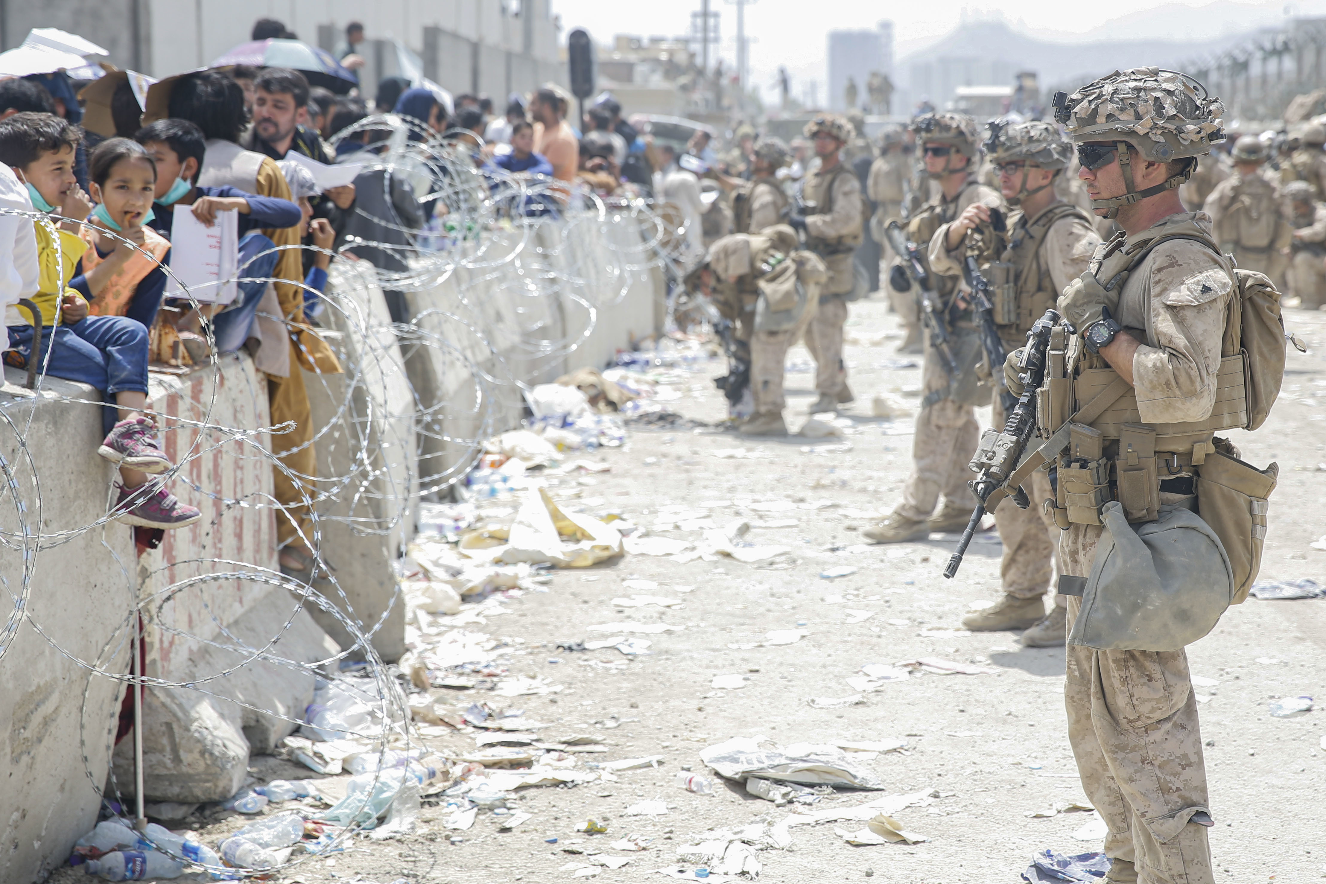 Marines with Special Purpose Marine Air-Ground Task Force–Crisis Response–Central Command provide assistance during evacuation at Hamid Karzai International Airport, Kabul, Afghanistan, August 20, 2021 (U.S. Marine Corps/Nicholas Guevara)